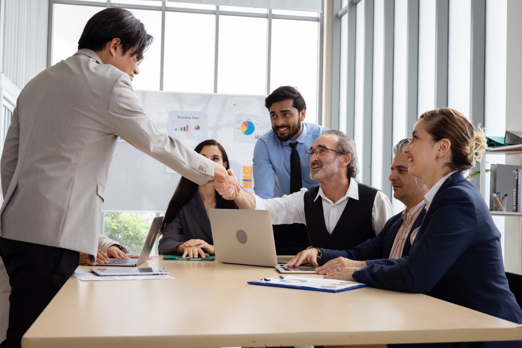 Group of people shaking hands in a business meeting